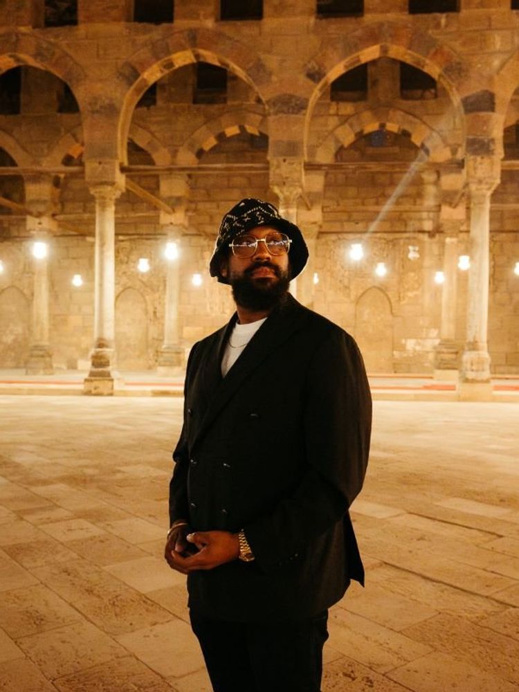 A photo of PJ Morton in an old Egyptian building.