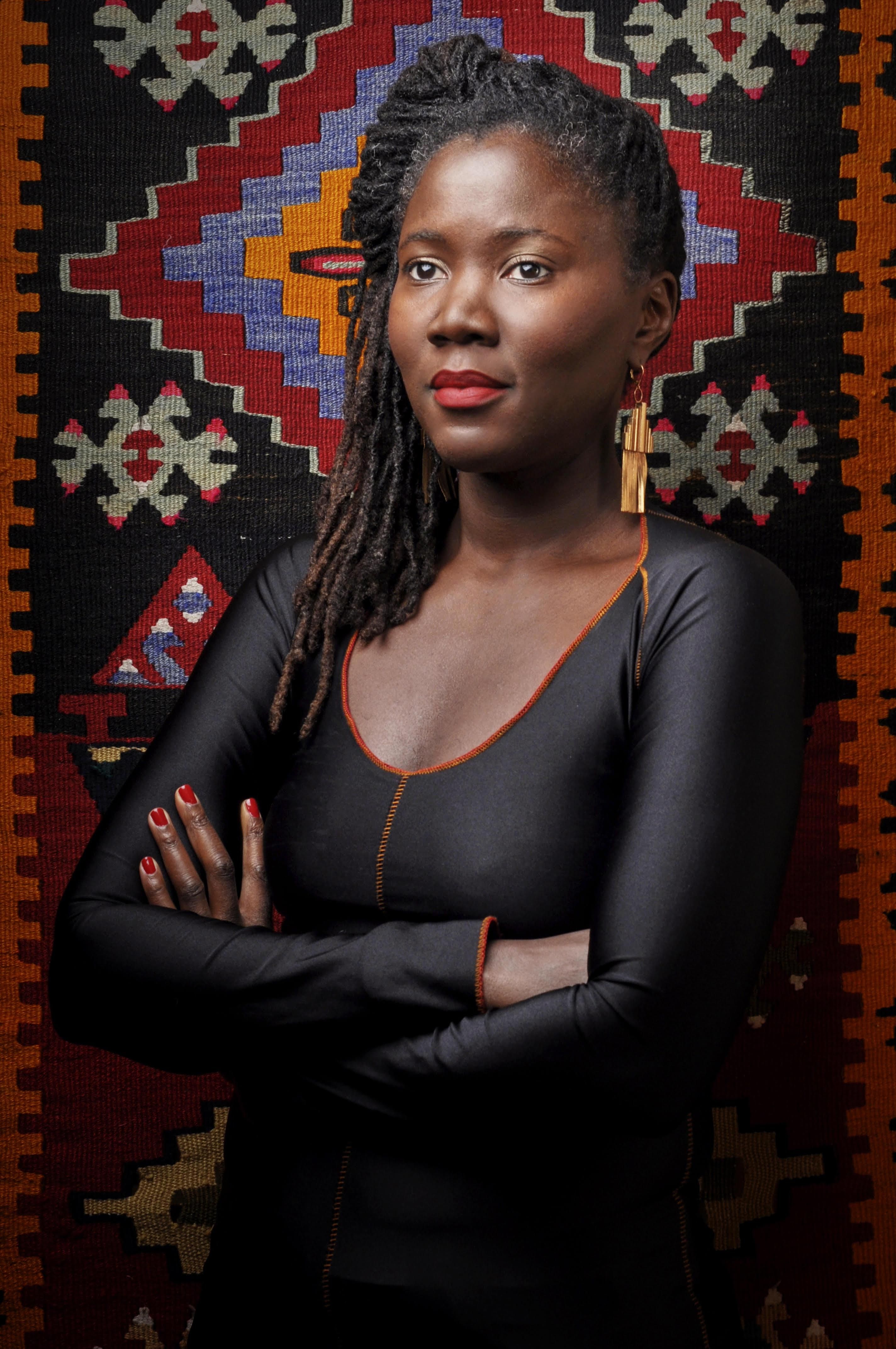 An image of filmmaker Alice Diop looking off to the side. 