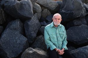 Playwright Athol Fugard poses for a portrait on the beach near his home in May 2004.