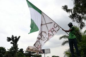 "Flag Boi" Akinwunmi Ibrahim Adebanjo waves the Nigerian flag together with a white flag with the inscription “EndSARS” as youth prepare to commemorate the first anniversary of the protest movement in Lagos, October 11, 2021.