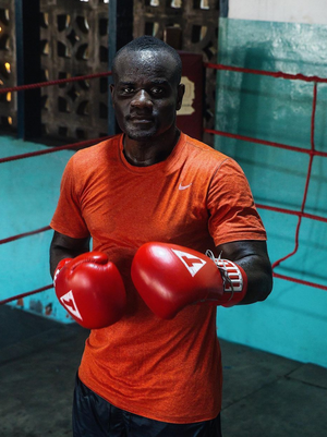 A man in a boxing ring with boxing gloves on