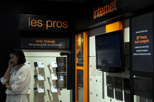 A woman talks on the phone at a new French internet operator Orange store in Tunis, on May 12, 2010.