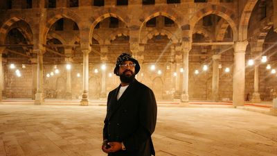 A photo of PJ Morton in an old Egyptian building.