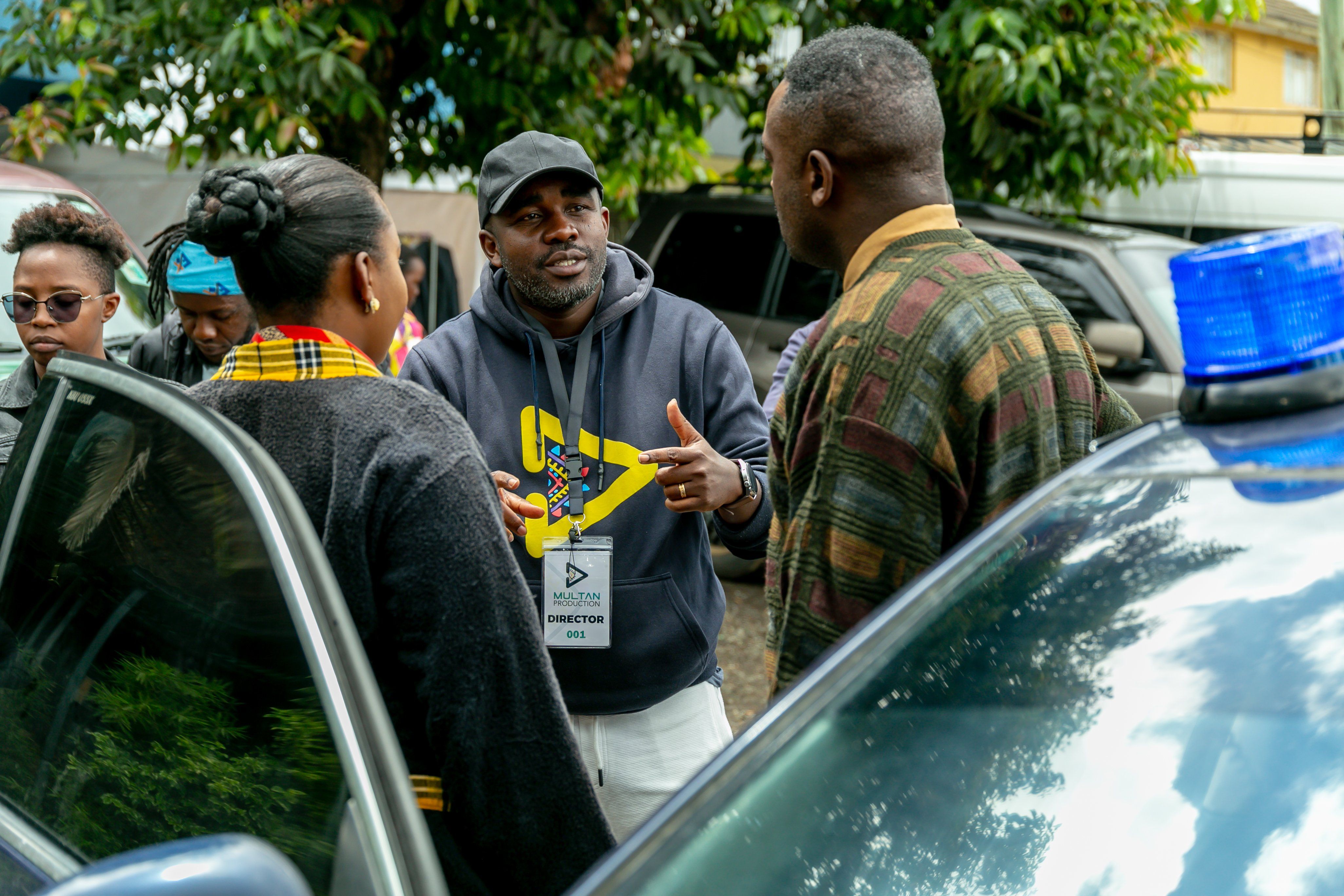 Reuben Odanga interacting with two cast members.