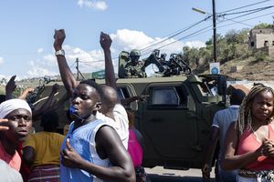 A military armored vehicle blocks the road as protesters try to make their way to the Ressano Garcia border post between Mozambique and South Africa on November 13, 2024. 